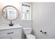 Clean bathroom with vanity, stylish fixtures, and window at 50 Peggy Ct, Raleigh, NC 27603