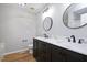 Bathroom with double sink vanity, dark wood cabinets, and modern fixtures at 50 Peggy Ct, Raleigh, NC 27603