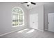Bright bedroom with large arched window, neutral walls, and carpet floors at 50 Peggy Ct, Raleigh, NC 27603
