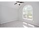 Bright bedroom with a ceiling fan, neutral walls, and a large arched window at 50 Peggy Ct, Raleigh, NC 27603