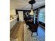 Stylish dining area with elegant lighting, dark walls and view into the kitchen at 50 Peggy Ct, Raleigh, NC 27603
