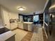 Well-lit kitchen featuring white cabinets, stainless steel appliances, and an open layout to the dining area at 50 Peggy Ct, Raleigh, NC 27603