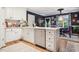 Charming kitchen featuring an island, white cabinetry, stainless appliances, and eat-in dining at 50 Peggy Ct, Raleigh, NC 27603