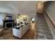 Open-concept living space with hardwood floors, fireplace, stairs, and view of dining area at 50 Peggy Ct, Raleigh, NC 27603