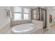 Luxurious soaking tub and glass enclosed shower offer a spa-like experience in this bathroom at 5104 Windmere Chase Dr, Raleigh, NC 27616