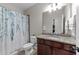 Bathroom featuring granite countertops, wood vanity, toilet, and shower/tub with a shower curtain at 5104 Windmere Chase Dr, Raleigh, NC 27616
