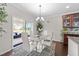 Dining room featuring a modern chandelier, light walls and sliding glass doors to a patio at 5104 Windmere Chase Dr, Raleigh, NC 27616