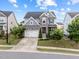 Two-story home with stone accents, attached garage, small front porch and well-manicured landscaping at 5104 Windmere Chase Dr, Raleigh, NC 27616