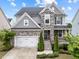 Charming two-story home with stone accents, attached garage, and well-manicured landscaping at 5104 Windmere Chase Dr, Raleigh, NC 27616