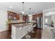 Kitchen with a large island featuring granite countertops, stainless steel appliances, and pendant lights at 5104 Windmere Chase Dr, Raleigh, NC 27616