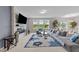 Bright living room featuring a stone fireplace, large windows and open to the dining area at 5104 Windmere Chase Dr, Raleigh, NC 27616