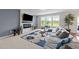 Cozy living room with a fireplace, large windows, and comfortable seating at 5104 Windmere Chase Dr, Raleigh, NC 27616