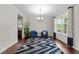 Open concept living room featuring hardwood floors, lots of light and two chairs at 5104 Windmere Chase Dr, Raleigh, NC 27616
