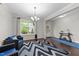 Open concept living room featuring hardwood floors, lots of light and furnishings at 5104 Windmere Chase Dr, Raleigh, NC 27616