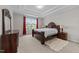 Spacious main bedroom with tray ceilings, plush carpet, and a large window with neighborhood views at 5104 Windmere Chase Dr, Raleigh, NC 27616