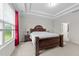 Bright and airy main bedroom boasts tray ceilings, plush carpet, and natural light at 5104 Windmere Chase Dr, Raleigh, NC 27616