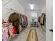 Spacious walk-in closet with ample hanging space, shelving, and natural light at 5104 Windmere Chase Dr, Raleigh, NC 27616