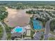 Beautiful aerial view displays community amenities: pool, tennis courts, playground, and a serene lake setting at 522 Crossview Ln, Durham, NC 27703