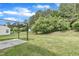 Expansive backyard features a concrete patio area, lush lawn and mature trees at 522 Crossview Ln, Durham, NC 27703