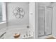 A bright bathroom features a soaking tub with decorative art and a glass-enclosed shower at 522 Crossview Ln, Durham, NC 27703