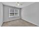 A bright, empty bedroom is carpeted and offers a ceiling fan at 522 Crossview Ln, Durham, NC 27703