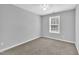 Bedroom features neutral walls, plush carpet, white trim, and a single window at 522 Crossview Ln, Durham, NC 27703