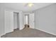 Bedroom features neutral walls, plush carpet, closet with folding doors and ceiling fan at 522 Crossview Ln, Durham, NC 27703