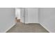 Bedroom features neutral walls, plush carpet, white trim, and double closet at 522 Crossview Ln, Durham, NC 27703