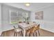Well lit dining room featuring modern furniture and decor with a view of the front yard at 522 Crossview Ln, Durham, NC 27703