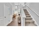 Grand foyer showcasing a staircase leading to a cozy living room with a fireplace at 522 Crossview Ln, Durham, NC 27703