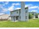 Back exterior of home features a covered patio and large grassy yard at 522 Crossview Ln, Durham, NC 27703