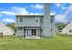 Back exterior of home features a covered patio, sliding glass doors and large yard at 522 Crossview Ln, Durham, NC 27703
