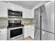 Modern kitchen with stainless steel appliances, granite counters, tiled backsplash, and white cabinets at 522 Crossview Ln, Durham, NC 27703