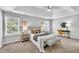 Bright main bedroom features neutral decor, tray ceiling, a sitting area, and ensuite access at 522 Crossview Ln, Durham, NC 27703
