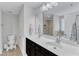 Bathroom featuring double sinks, marble counters, and a large mirror at 5412 Robbins Dr, Raleigh, NC 27610