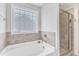 Bright bathroom with a soaking tub and separate glass shower at 5412 Robbins Dr, Raleigh, NC 27610