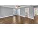 Spacious bedroom with hardwood floors, ceiling fan, walk-in closet, and natural light at 5412 Robbins Dr, Raleigh, NC 27610
