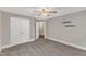 Bedroom offering neutral paint, carpet, ceiling fan, shelves, and double doors at 5412 Robbins Dr, Raleigh, NC 27610