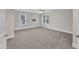Spacious bedroom offering neutral paint, carpet, ceiling fan, and two sunny windows at 5412 Robbins Dr, Raleigh, NC 27610