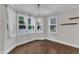 Elegant dining room featuring hardwood floors, large windows with curtains, and a stylish chandelier at 5412 Robbins Dr, Raleigh, NC 27610