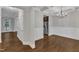 Open dining room with hardwood floors, coffered ceilings, and stainless steel refrigerator at 5412 Robbins Dr, Raleigh, NC 27610