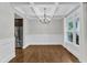 Dining area featuring hardwood floors, a chandelier, coffered ceiling and large window at 5412 Robbins Dr, Raleigh, NC 27610