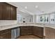 Open kitchen with granite countertops, stainless steel appliances, and seamless flow to the living and dining areas at 5412 Robbins Dr, Raleigh, NC 27610
