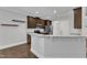 Modern kitchen with stainless steel appliances, granite countertops, tile backsplash, and dark wood cabinetry at 5412 Robbins Dr, Raleigh, NC 27610