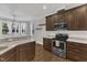 Kitchen area with granite countertops, stainless steel appliances, and open layout to the dining area at 5412 Robbins Dr, Raleigh, NC 27610