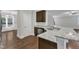 View of the kitchen's granite countertops and stainless steel sink, open to dining and living areas at 5412 Robbins Dr, Raleigh, NC 27610