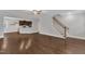 Spacious living area boasts hardwood floors, a staircase, and an open layout to the kitchen, perfect for modern living at 5412 Robbins Dr, Raleigh, NC 27610