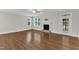 Spacious living room featuring hardwood floors, a fireplace, and multiple windows at 5412 Robbins Dr, Raleigh, NC 27610