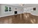 Open-concept living room with a fireplace and hardwood floors, seamlessly connected to the kitchen at 5412 Robbins Dr, Raleigh, NC 27610