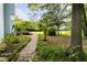 A beautiful backyard features a brick walkway and manicured plants at 59 Troy Dr, Fuquay Varina, NC 27526